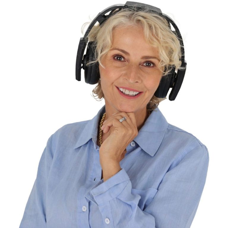 headshot of older lady in blue shirt where axon headset smiling at the camera